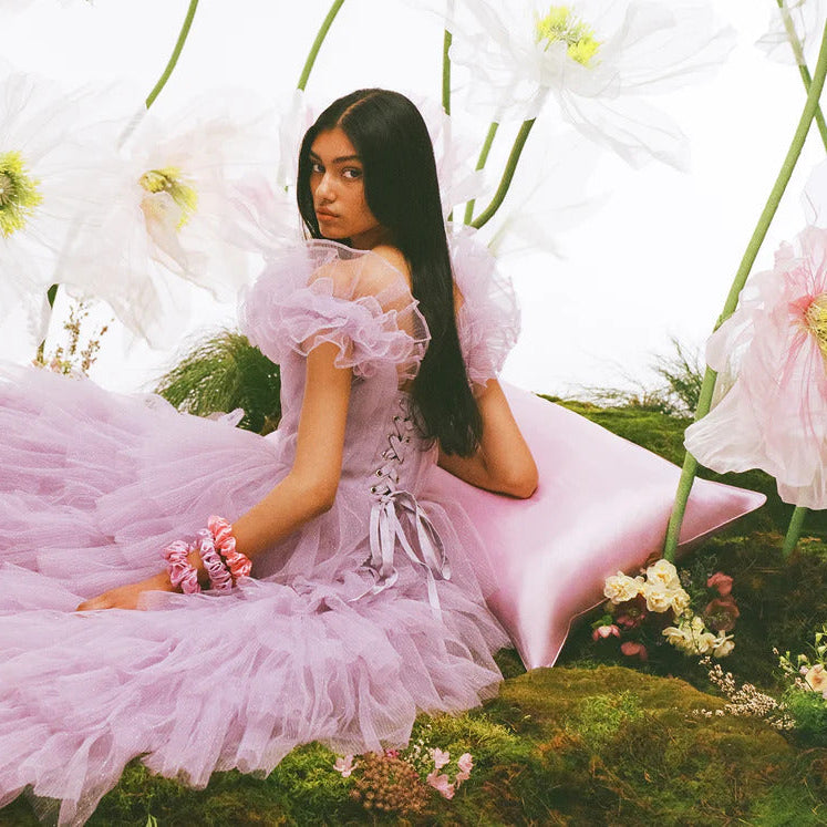 A lady with a pink pillow